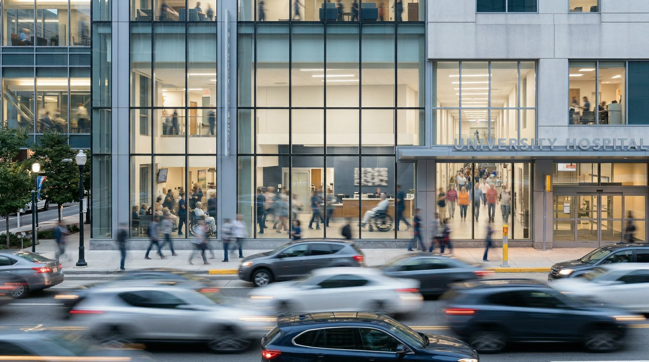 Motion-blurred pedestrians and traffic outside a busy university hospital